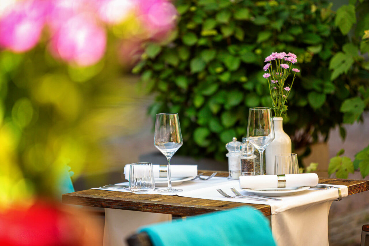 Gedeckter Tisch im Hofgarten des Restaurants alto